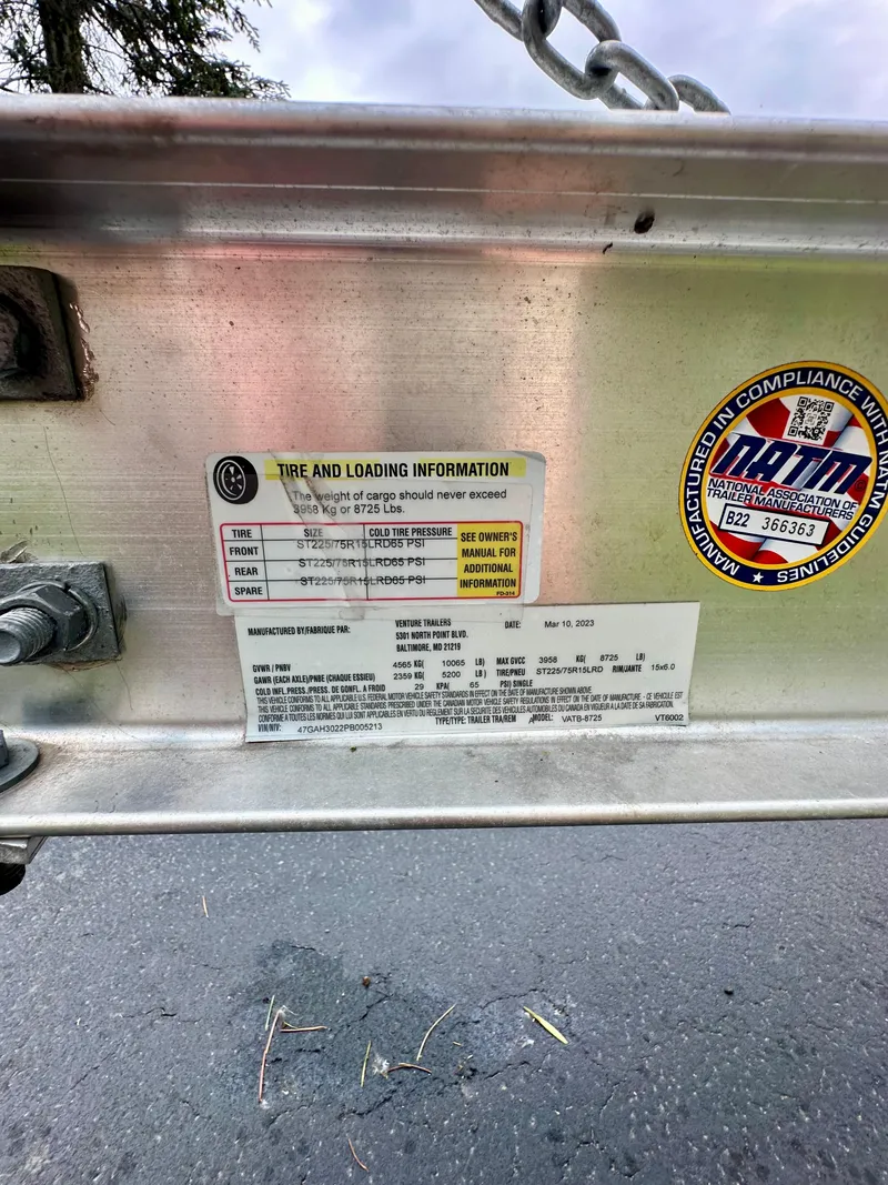 Slide: The Image of Tire and loading information label on a 2023 Regal 2800 Bowrider boat trailer. - 23