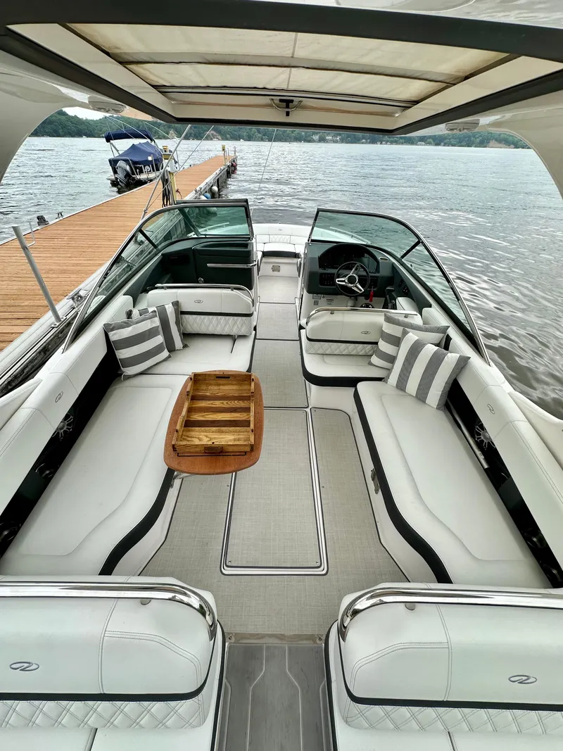 Slide: The Image of 2023 Regal 2800 Bowrider boat interior with luxurious seating and striped cushions. - 5