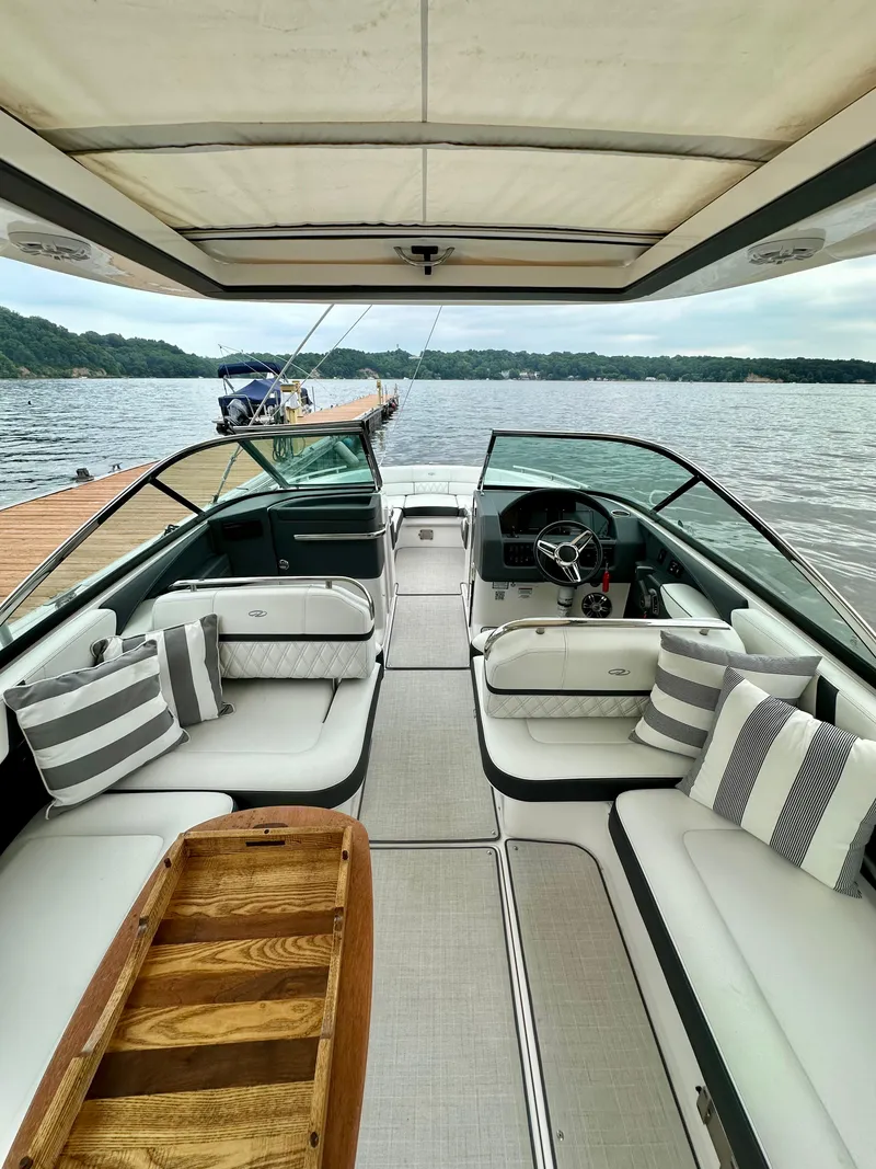 Slide: The Image of 2023 Regal 2800 Bowrider interior with luxurious seating and lake view. - 6