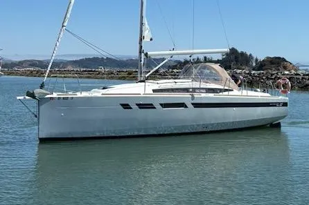 Slide: The Image of 2021 Jeanneau Sun Odyssey 349 sailboat on calm water, clear sky background. - 1