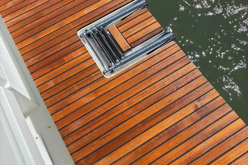 Slide: The Image of Teak deck of 2021 Jeanneau Sun Odyssey 349 yacht with folding ladder. - 10