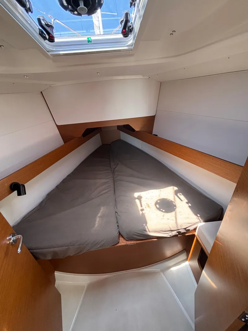 Slide: The Image of Cabin interior of 2021 Jeanneau Sun Odyssey 349 sailboat with skylight and cozy bedding. - 19