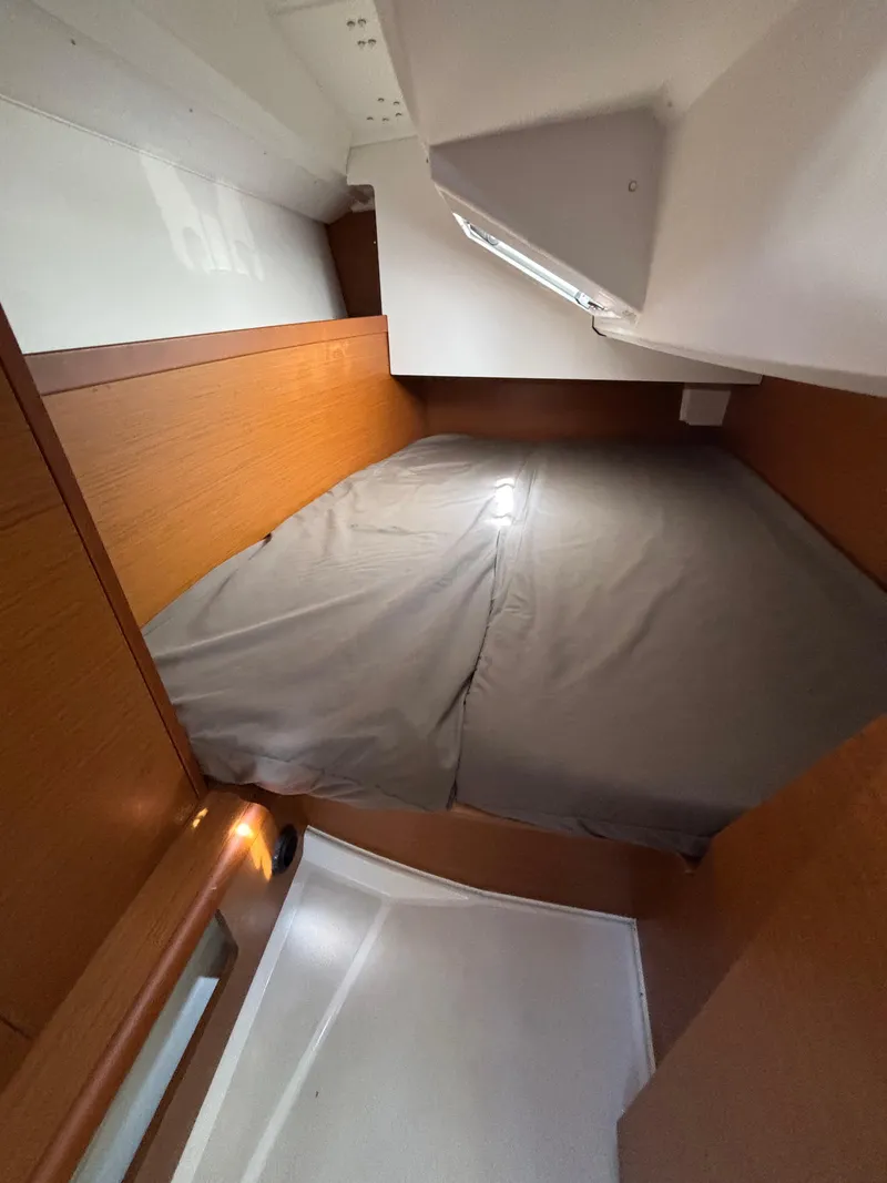 Slide: The Image of Cozy cabin interior of 2021 Jeanneau Sun Odyssey 349 sailboat with wooden accents. - 21