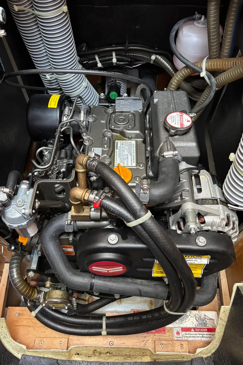 Slide: The Image of Engine compartment of a 2021 Jeanneau Sun Odyssey 349 sailboat, showcasing detailed mechanical components. - 25