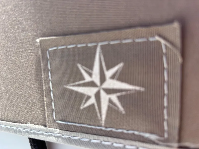 Slide: The Image of Close-up of a stitched compass rose emblem on Jeanneau Sun Odyssey 349, 2021 model. - 27