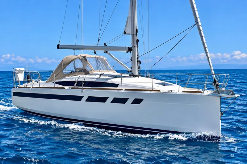 The Image of 2021 Jeanneau Sun Odyssey 349 sailing on open blue sea under clear sky. - 0