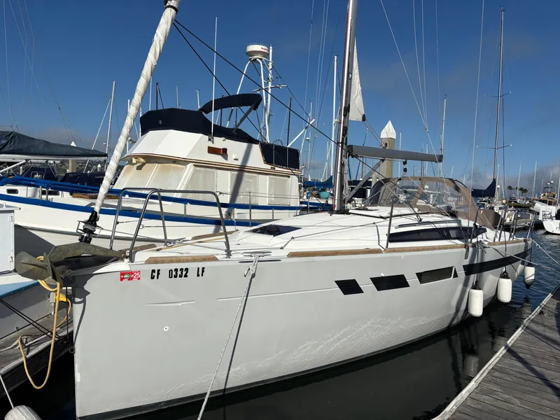 Slide: The Image of 2021 Jeanneau Sun Odyssey 349 sailboat docked at marina under clear blue sky. - 5
