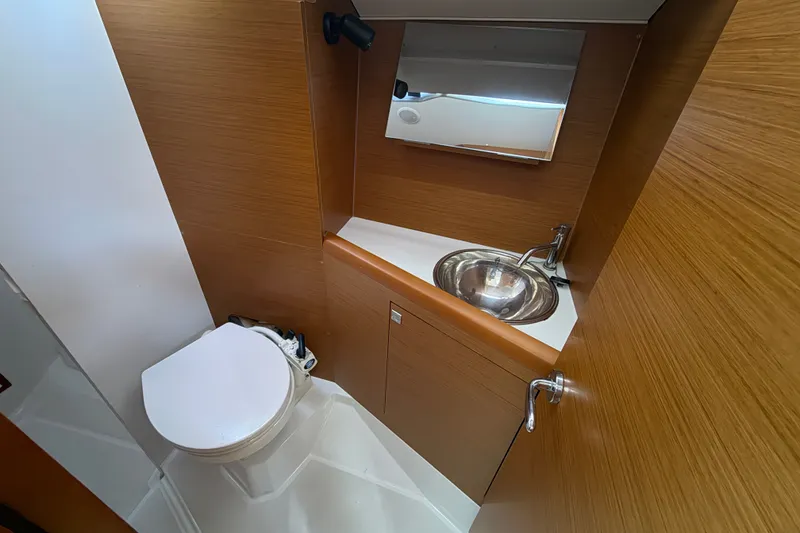 Slide: The Image of Compact bathroom in 2021 Jeanneau Sun Odyssey 349 yacht with sink and toilet. - 17