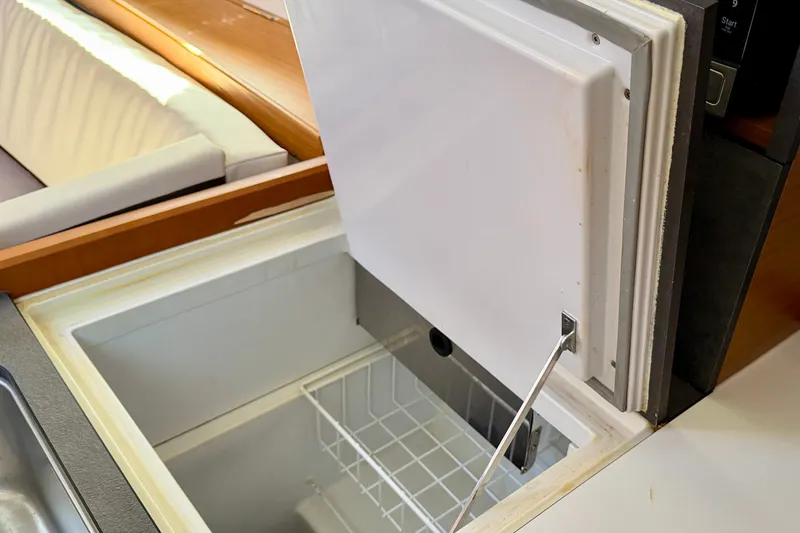 Slide: The Image of Open freezer compartment in 2021 Jeanneau Sun Odyssey 349 yacht interior. - 34