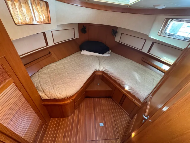 Slide: The Image of Cozy cabin interior of 2003 President Performance Trawler with wood paneling and comfortable bedding. - 11