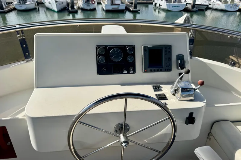 Slide: The Image of Helm of 2003 President Performance Trawler with steering wheel and navigation controls. - 14