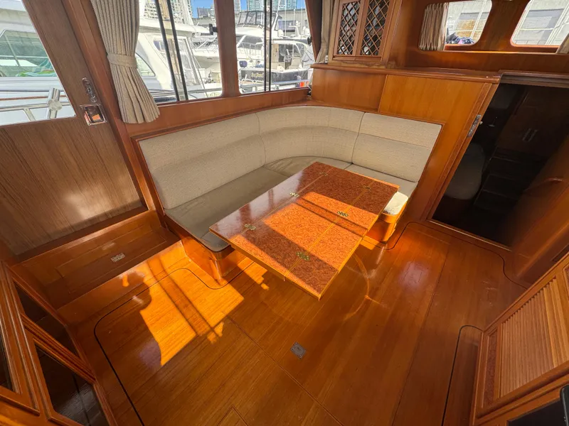 Slide: The Image of 2003 President Performance Trawler interior with wooden flooring and cushioned seating area. - 3
