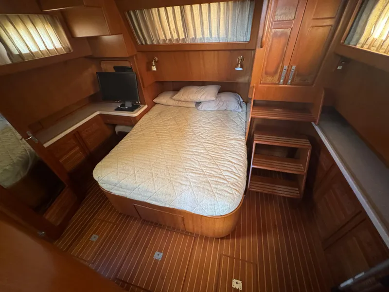 Slide: The Image of Cozy cabin interior of 2003 President Performance Trawler with bed and wooden furnishings. - 9