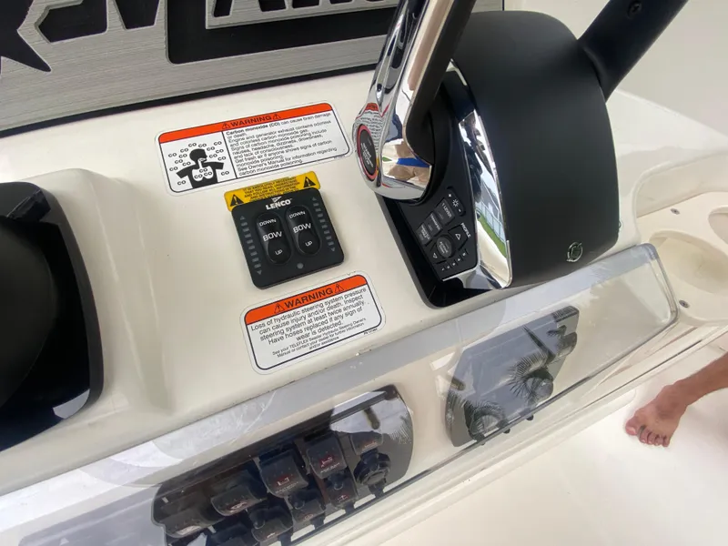 Slide: The Image of Control panel of a 2011 Mako 284 CC boat with warning labels and throttle. - 22