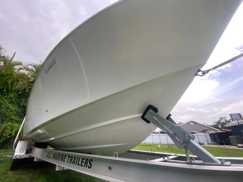 Slide: The Image of 2011 Mako 284 CC boat on trailer, side view, outdoors. - 3
