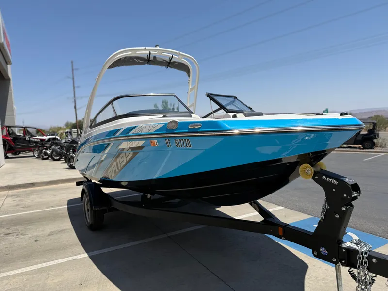Slide: The Image of 2021 Yamaha Boats AR195 in blue on trailer, parked outdoors. - 12