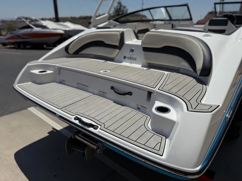 Slide: The Image of 2021 Yamaha Boats AR195 rear deck with seating and cup holders. - 14