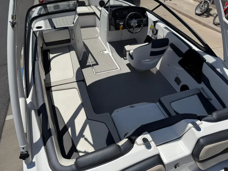 Slide: The Image of 2021 Yamaha Boats AR195 interior with spacious seating and modern dashboard. - 16