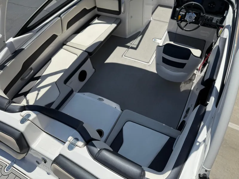 Slide: The Image of 2021 Yamaha Boats AR195 interior with sleek seating and modern dashboard design. - 17