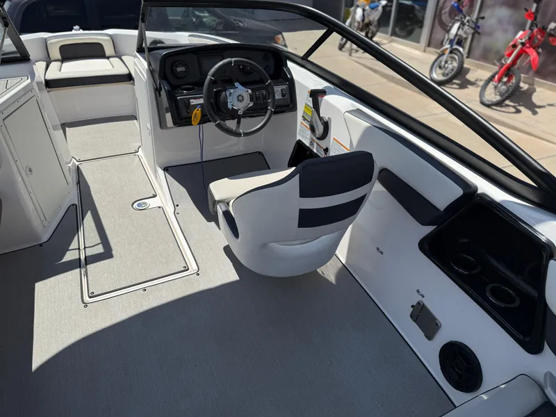 Slide: The Image of 2021 Yamaha AR195 boat interior with steering wheel and seating area. - 18