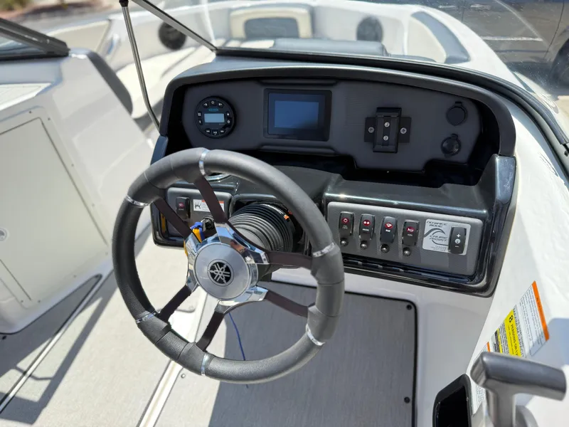 Slide: The Image of 2021 Yamaha AR195 boat dashboard with steering wheel and control panel. - 21