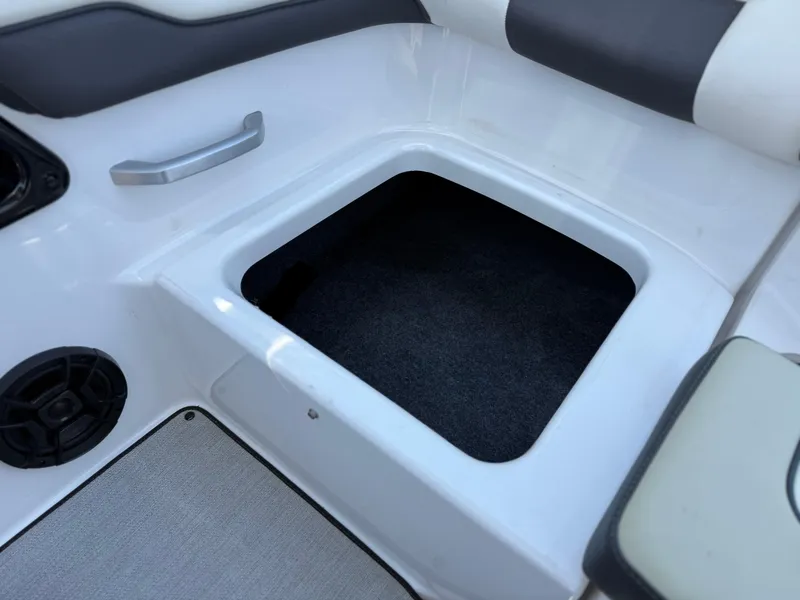 Slide: The Image of 2021 Yamaha AR195 boat interior storage compartment with speaker and handle. - 24