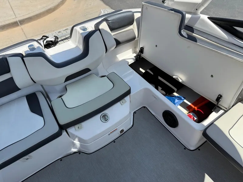 Slide: The Image of 2021 Yamaha AR195 boat interior with open storage compartment and seating. - 25
