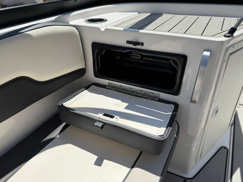 Slide: The Image of 2021 Yamaha AR195 boat interior with open storage compartment and cushioned seating. - 28