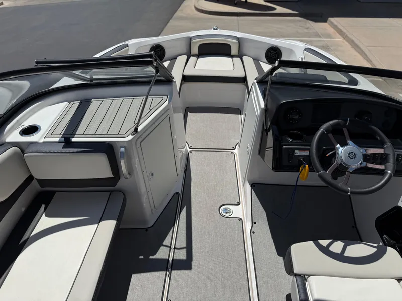 Slide: The Image of 2021 Yamaha Boats AR195 interior with steering wheel and seating area. - 30