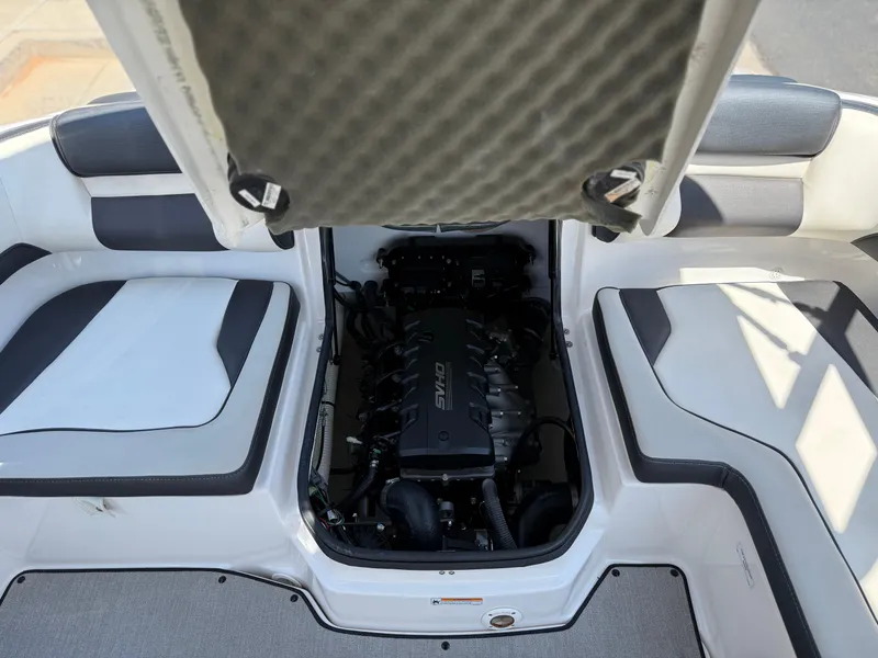 Slide: The Image of 2021 Yamaha AR195 boat engine compartment with open hatch, showcasing interior seating and engine details. - 31