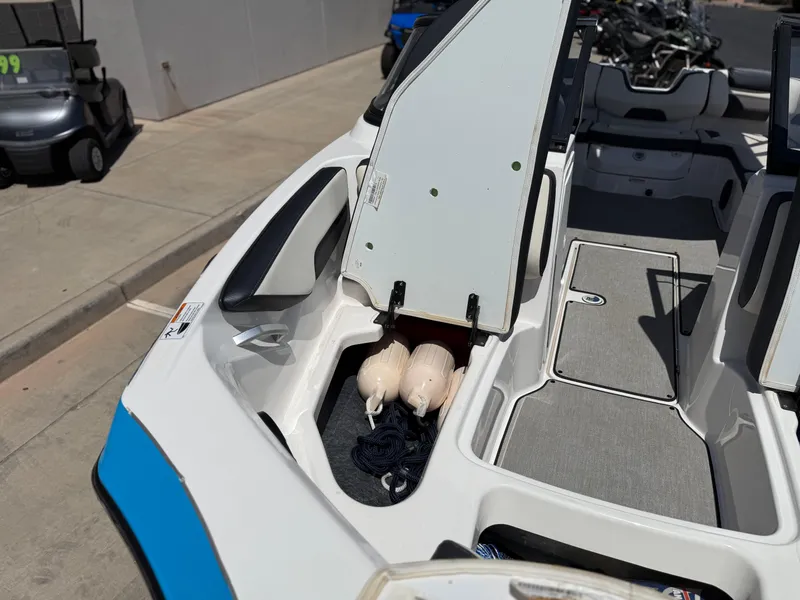 Slide: The Image of 2021 Yamaha AR195 boat with open storage compartment, showing fenders and rope. - 32