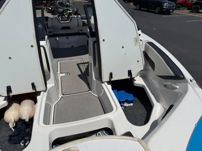 Slide: The Image of 2021 Yamaha Boats AR195 interior with open storage compartments and visible accessories. - 33