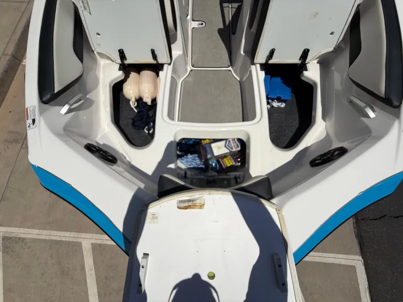 Slide: The Image of 2021 Yamaha Boats AR195 interior with open storage compartments and visible accessories. - 34