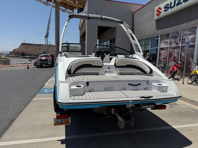 Slide: The Image of 2021 Yamaha AR195 boat storage compartment with safety equipment and trash bin. - 6