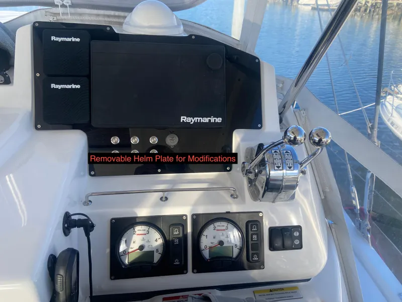 Slide: The Image of Helm controls of a 2020 Robertson Leopard boat with Raymarine equipment and modification options. - 14