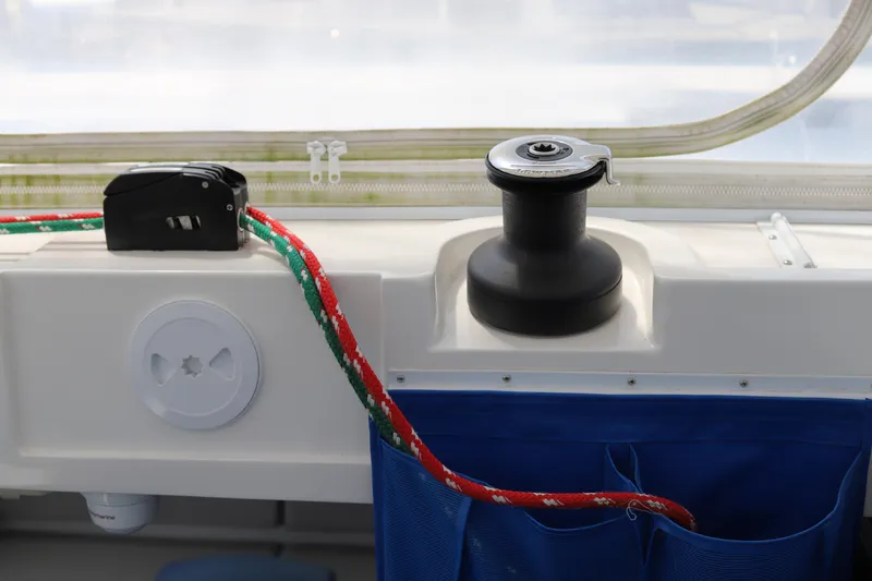Slide: The Image of Sailing equipment on a 2020 Robertson Leopard boat, featuring a winch and colorful rope. - 21