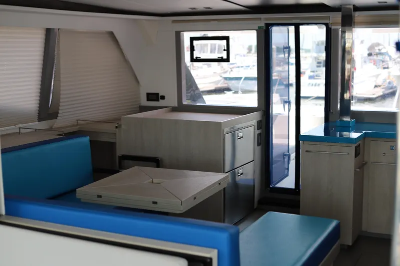 Slide: The Image of Modern interior of a 2020 Robertson Leopard yacht with blue seating and sleek cabinetry. - 24
