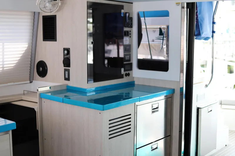 Slide: The Image of Modern interior of a 2020 Robertson Leopard yacht with sleek cabinetry and blue countertops. - 27