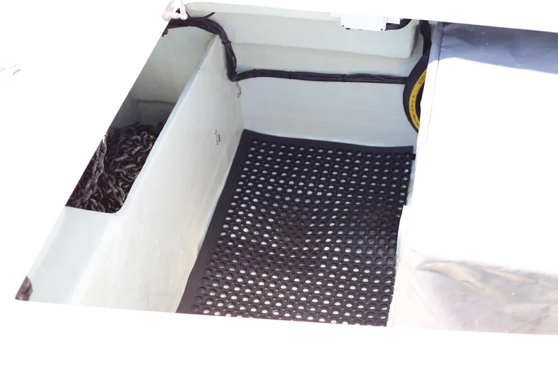Slide: The Image of Open compartment in a 2020 Robertson Leopard boat, featuring a black perforated mat. - 32