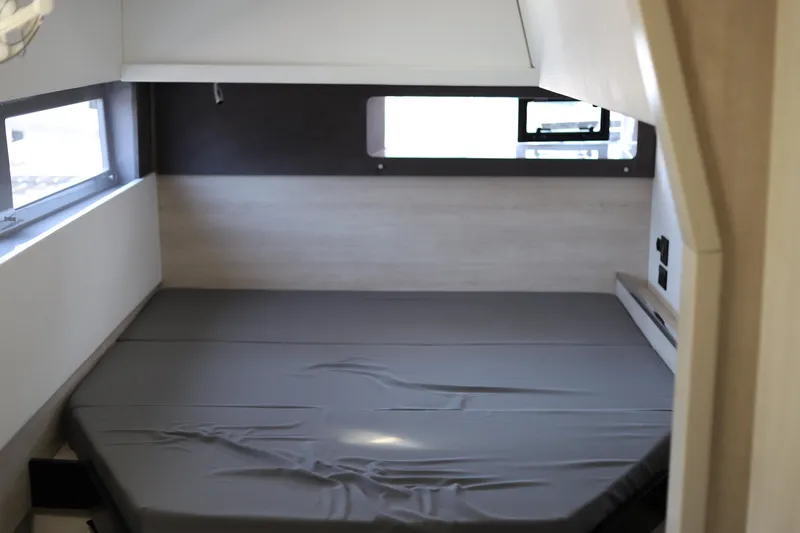 Slide: The Image of Compact cabin interior with a bed in a 2020 Robertson Leopard model. - 41