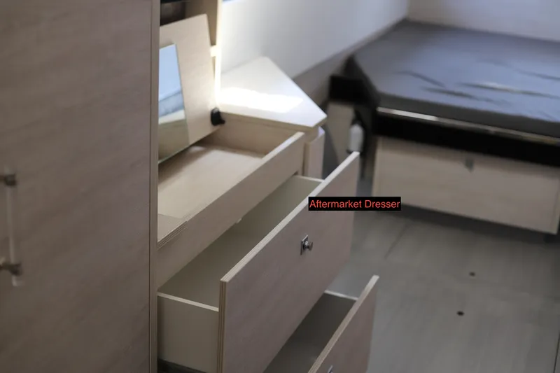Slide: The Image of Modern aftermarket dresser in a Robertson Leopard 2020 interior, featuring open drawers and a mirror. - 43