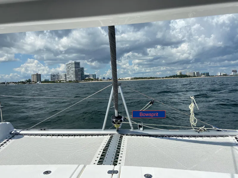 Slide: The Image of Sailing on a 2020 Robertson Leopard catamaran with bowsprit, city skyline in background. - 6