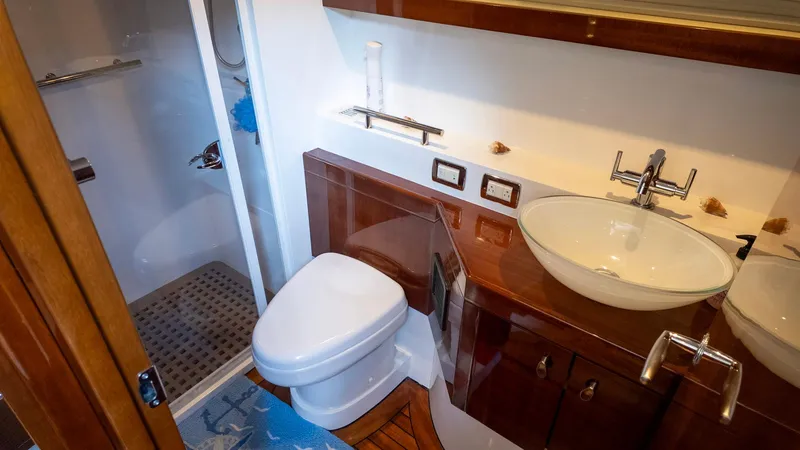 Slide: The Image of Luxurious bathroom in 2008 Savannah 54 yacht with modern fixtures and wooden accents. - 15