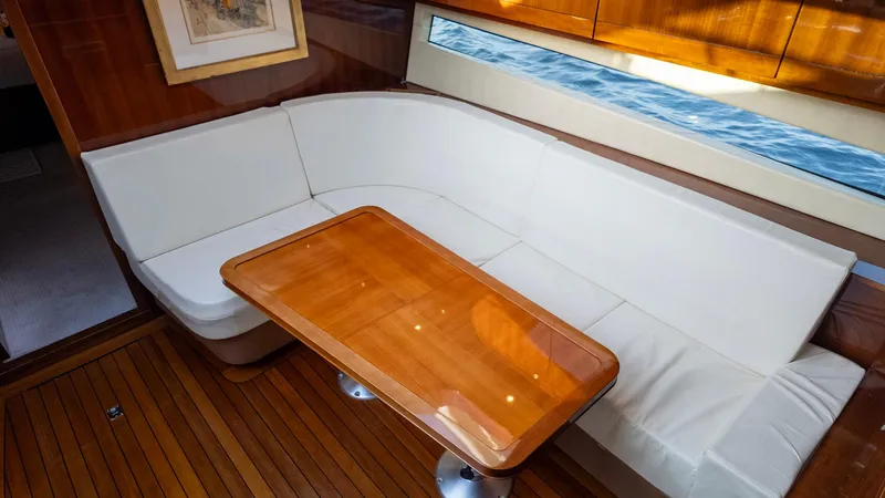 Slide: The Image of Luxurious interior of 2008 Savannah 54 yacht with white seating and wooden table. - 21