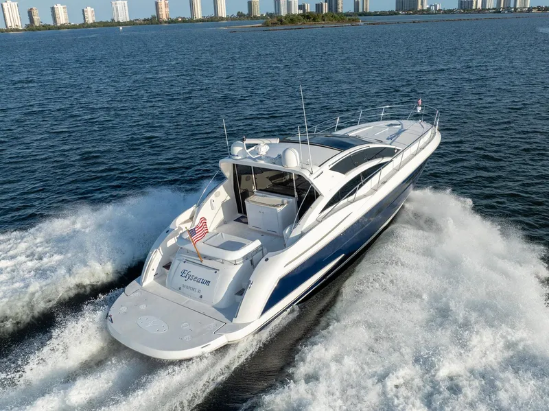 Slide: The Image of Savannah 54 yacht cruising on open water, 2008 model, with city skyline in background. - 8