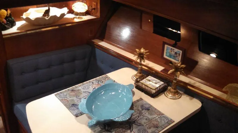Slide: The Image of Cozy dining area inside a 1973 Trojan F-32 boat with elegant decor. - 10