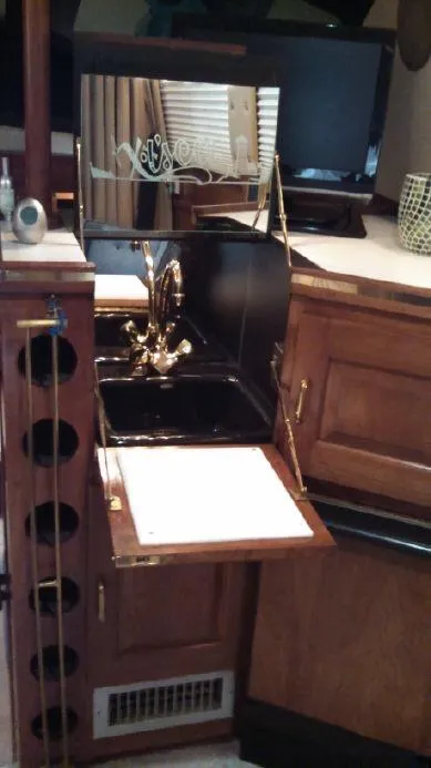 Slide: The Image of 1973 Trojan F-32 yacht interior with wooden cabinetry and compact sink area. - 6