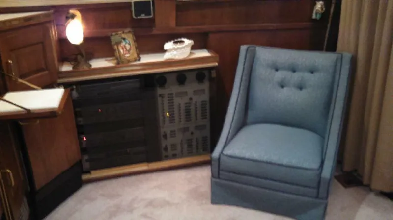 Slide: The Image of 1973 Trojan F-32 interior with blue chair, vintage decor, and control panel. - 7