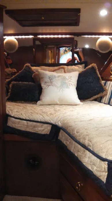 Slide: The Image of Cozy cabin interior of a 1973 Trojan F-32 boat with plush bedding and decorative pillows. - 9