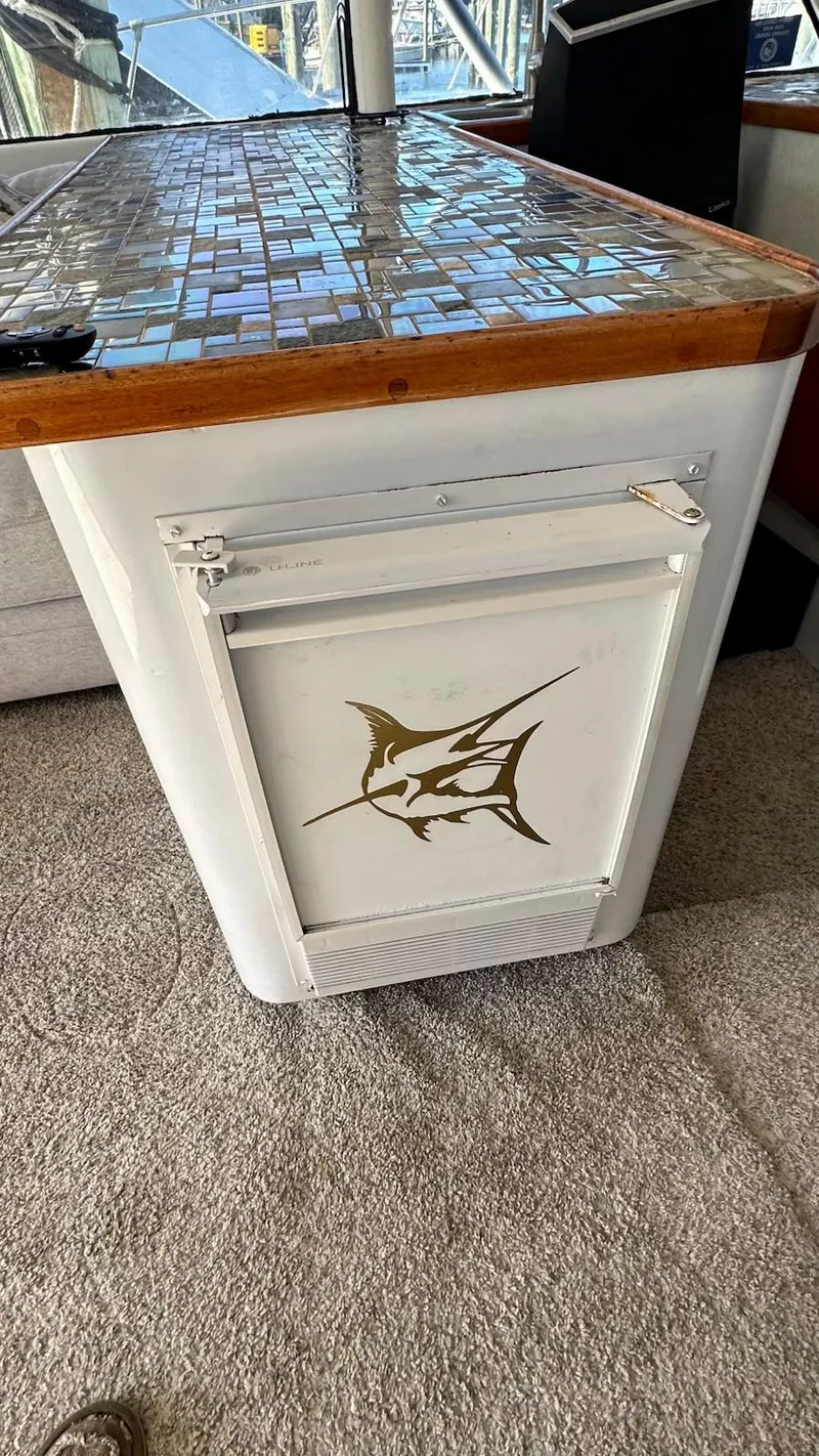 Slide: The Image of 1979 Buddy Davis 46 Convertible interior with mosaic countertop and marlin design on cabinet. - 13